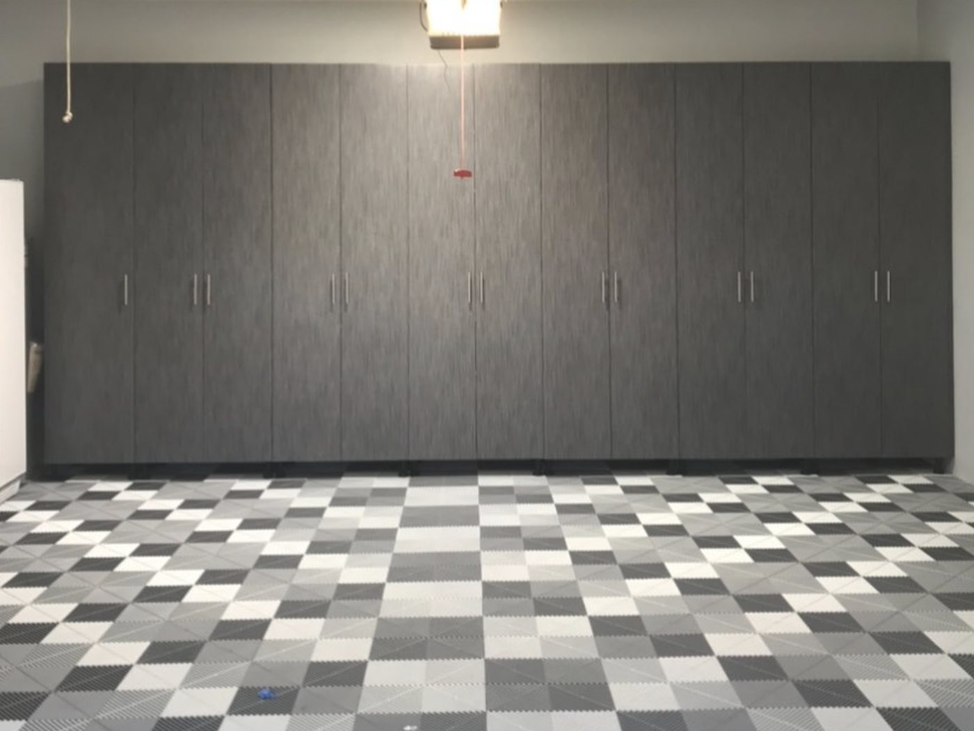 Custom floor to ceiling gray garage cabinets