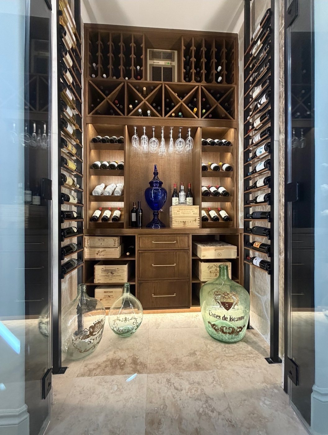 Custom wine room with lighted wood racking and glass doors